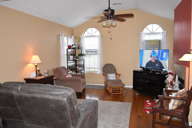 living room featuring vaulted ceiling, ceiling fan, dark hardwood / wood-style flooring, and a healthy amount of sunlight