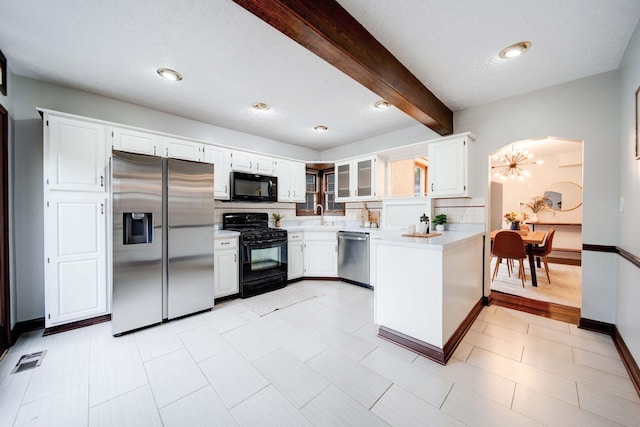 kitchen featuring beam ceiling, white cabinetry, an inviting chandelier, tasteful backsplash, and black appliances