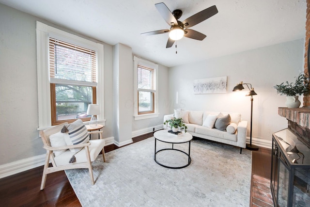 living room featuring hardwood / wood-style flooring and ceiling fan