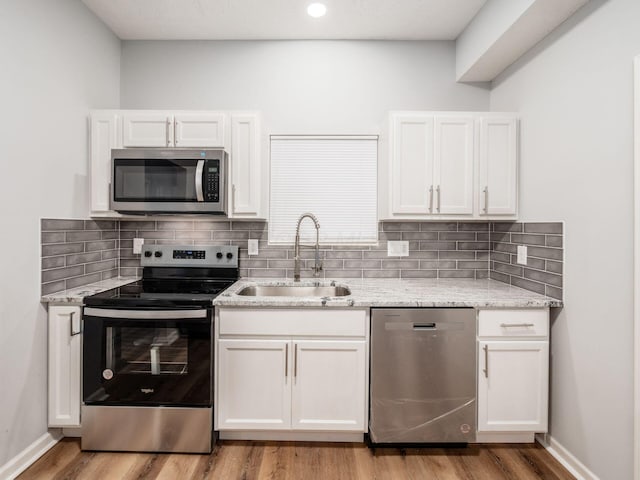 kitchen featuring sink, white cabinets, and appliances with stainless steel finishes