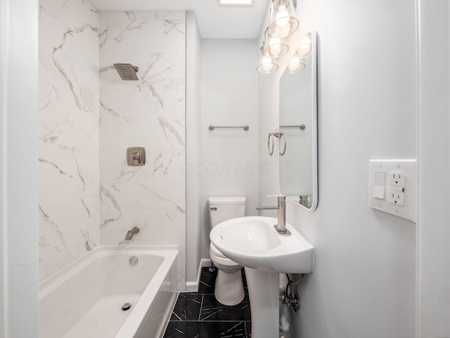 bathroom featuring tiled shower / bath combo and toilet