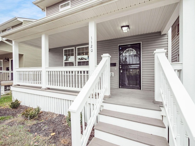 view of exterior entry featuring a porch