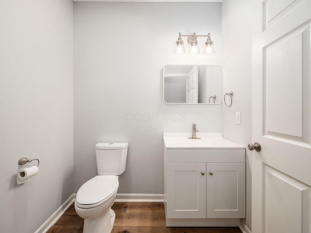 bathroom featuring hardwood / wood-style floors, vanity, and toilet