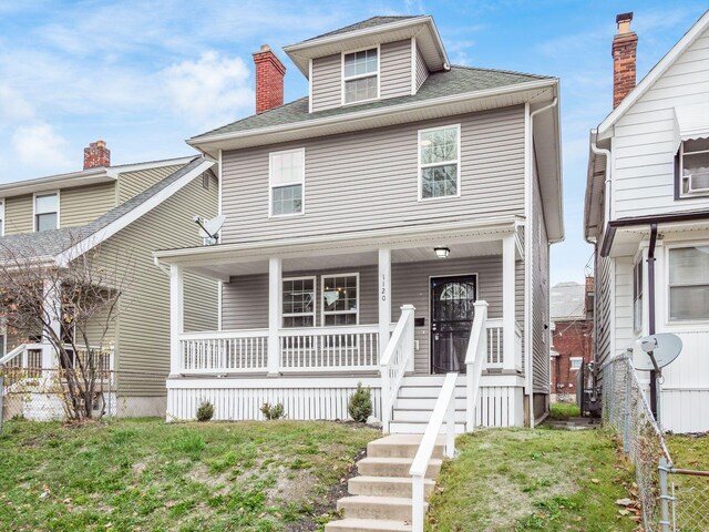 view of front of house with a porch and a front lawn