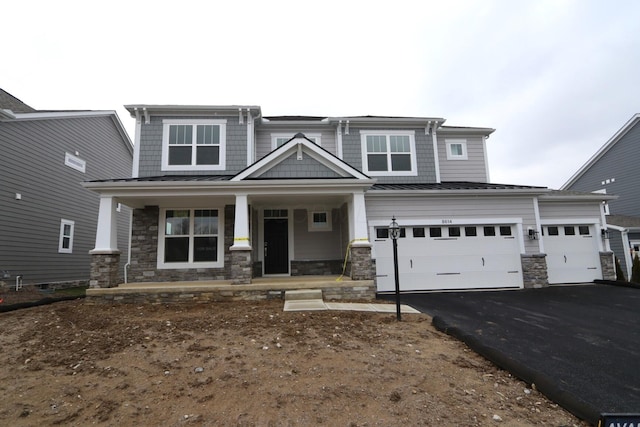 craftsman inspired home with a garage and a porch