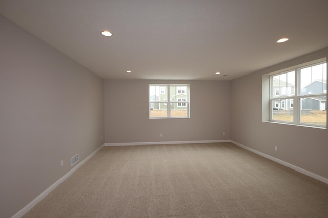 unfurnished room featuring recessed lighting, visible vents, baseboards, and light carpet