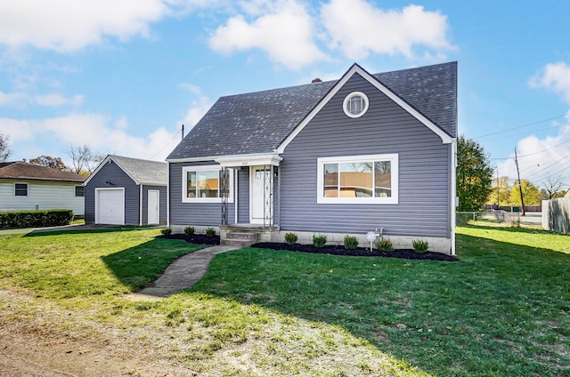 view of front facade featuring an outbuilding, a garage, and a front lawn