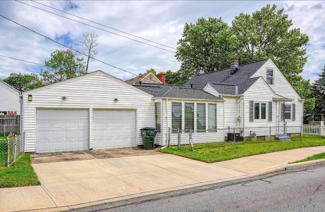 view of front of property with a garage and a front lawn