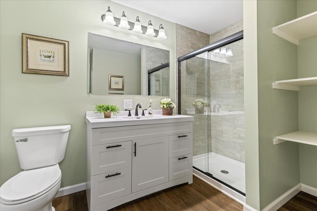 bathroom featuring wood-type flooring, a shower with shower door, and toilet