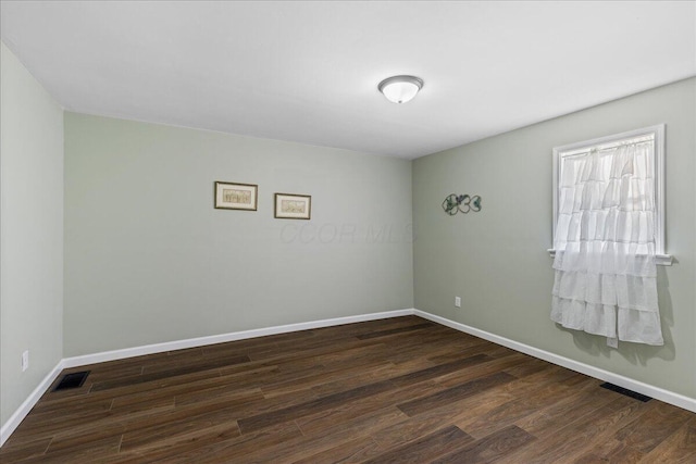 unfurnished room featuring dark hardwood / wood-style flooring