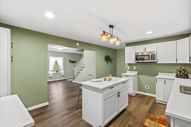 kitchen with white cabinets and decorative light fixtures