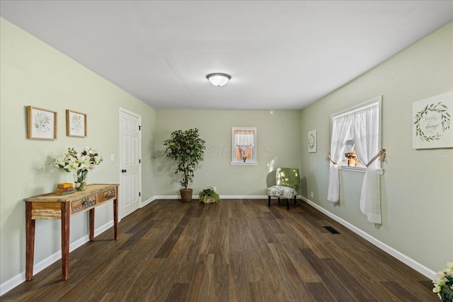 unfurnished room with dark wood-type flooring