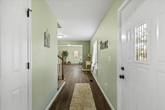 corridor with dark hardwood / wood-style flooring