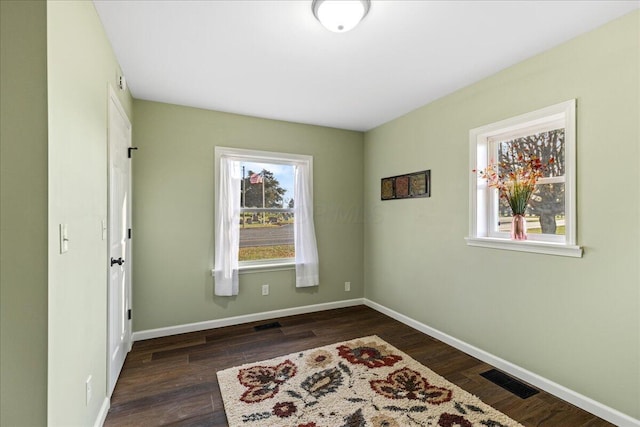 spare room featuring dark hardwood / wood-style flooring