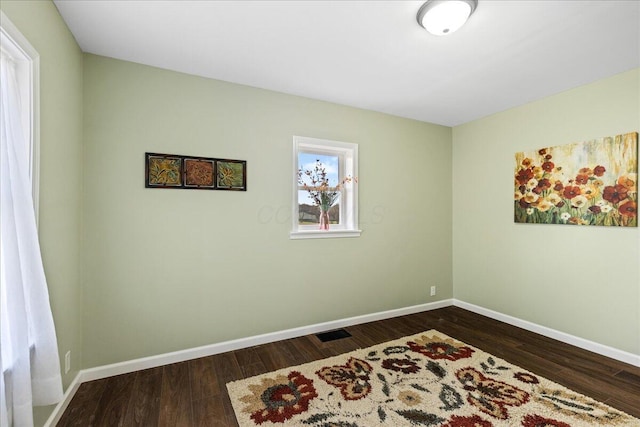 unfurnished room featuring dark wood-type flooring