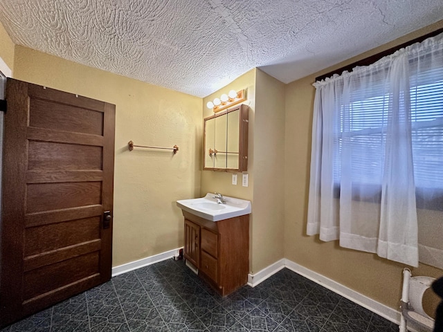 bathroom with vanity and a textured ceiling