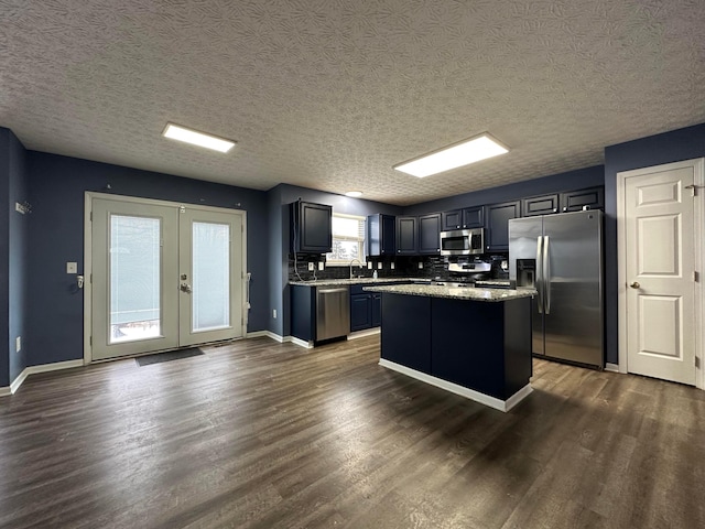 kitchen with a kitchen island, dark hardwood / wood-style flooring, sink, and appliances with stainless steel finishes