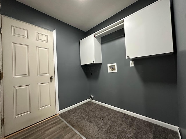 laundry area featuring cabinets, washer hookup, and dark wood-type flooring