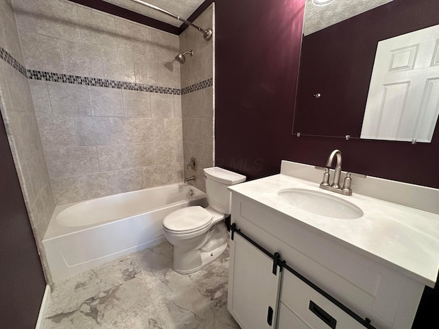 full bathroom with vanity, toilet, a textured ceiling, and tiled shower / bath