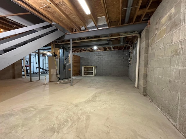 basement featuring heating unit and gas water heater