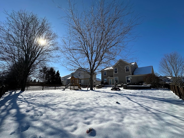 snowy yard with a playground