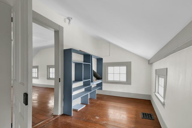 empty room featuring lofted ceiling and dark hardwood / wood-style floors