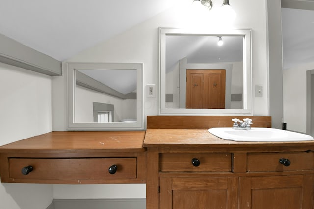 bathroom with vanity and vaulted ceiling