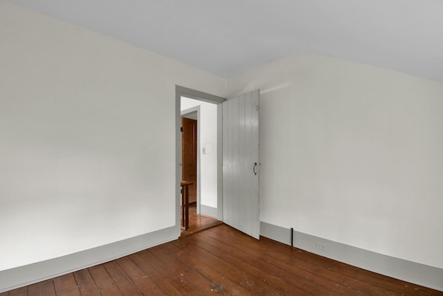 empty room with dark hardwood / wood-style flooring