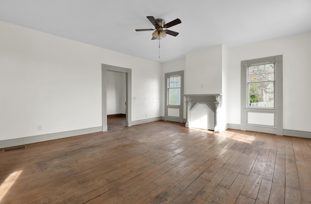 unfurnished living room featuring hardwood / wood-style flooring and ceiling fan