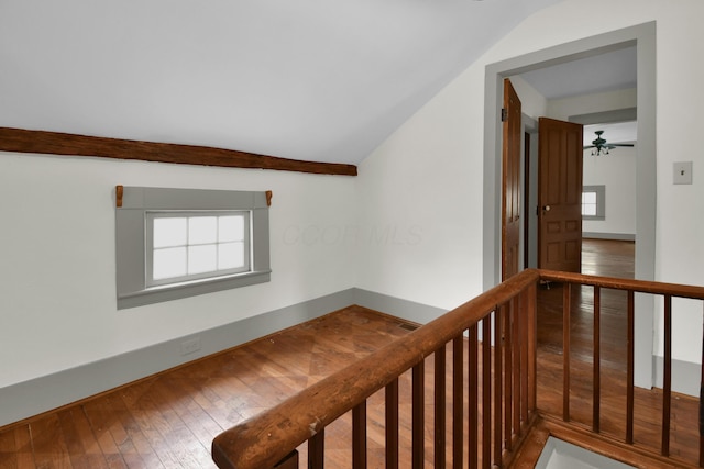 hall featuring hardwood / wood-style floors and vaulted ceiling