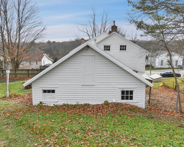 view of property exterior with a yard