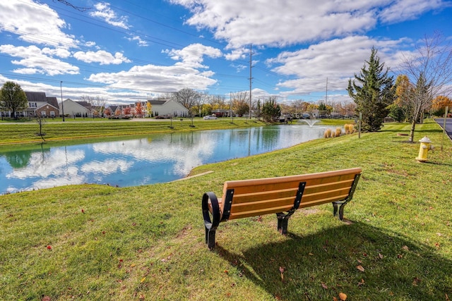 view of community with a lawn and a water view