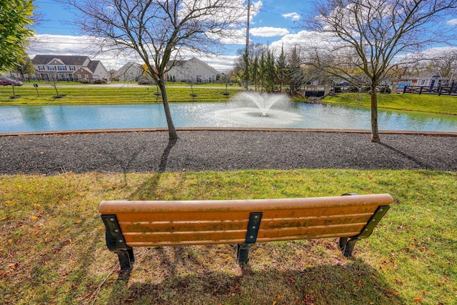 view of community with a water view and a yard