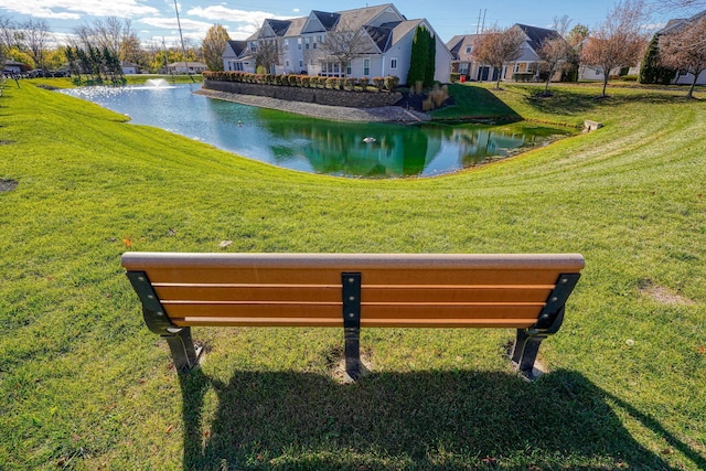 view of community with a water view and a yard