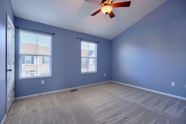 carpeted empty room with ceiling fan and lofted ceiling