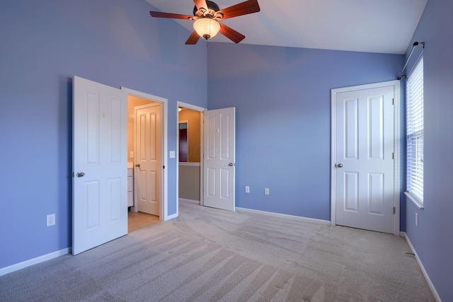 unfurnished bedroom featuring multiple windows, ceiling fan, and light carpet