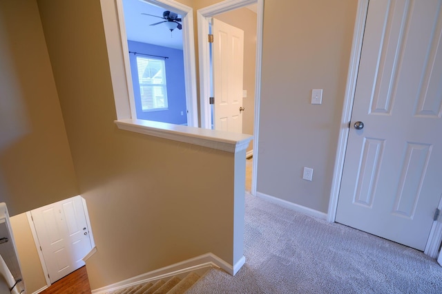 hall featuring light colored carpet