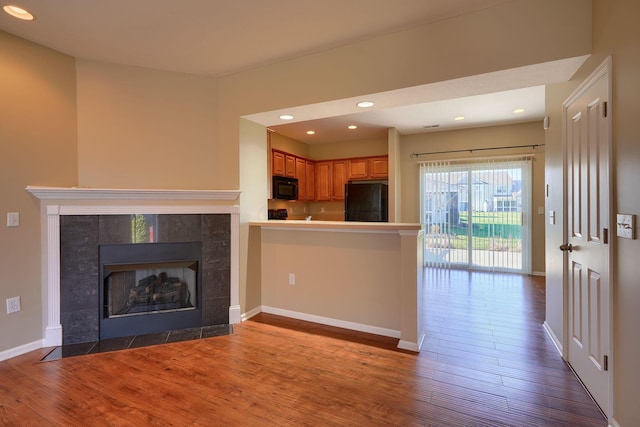 unfurnished living room with a fireplace and dark hardwood / wood-style floors