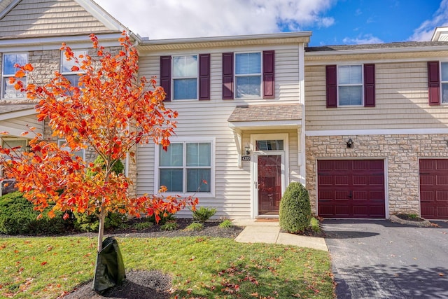 townhome / multi-family property featuring a garage