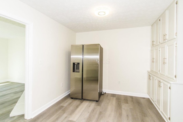 kitchen featuring white cabinetry, stainless steel fridge with ice dispenser, and light wood-type flooring