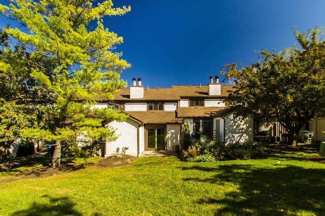 rear view of house with a yard