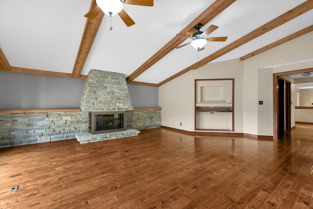 unfurnished living room with vaulted ceiling with beams, ceiling fan, a fireplace, and hardwood / wood-style flooring