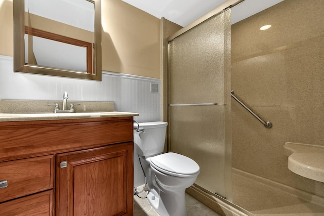 bathroom featuring an enclosed shower, vanity, and toilet