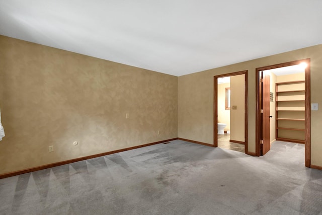 spare room featuring light carpet