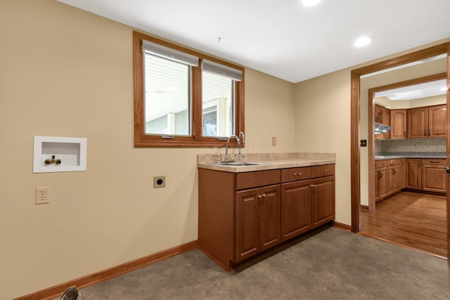 kitchen featuring dark hardwood / wood-style flooring, tasteful backsplash, stainless steel cooktop, ventilation hood, and sink