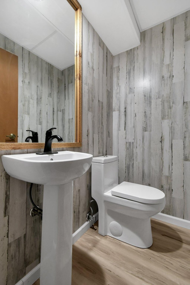 bathroom featuring hardwood / wood-style flooring, toilet, and sink