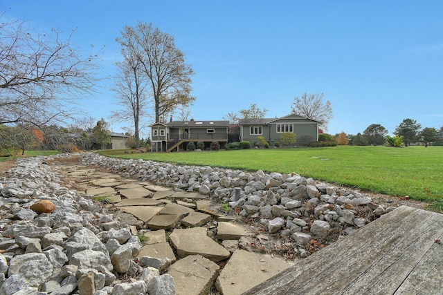 rear view of property with a yard and a deck