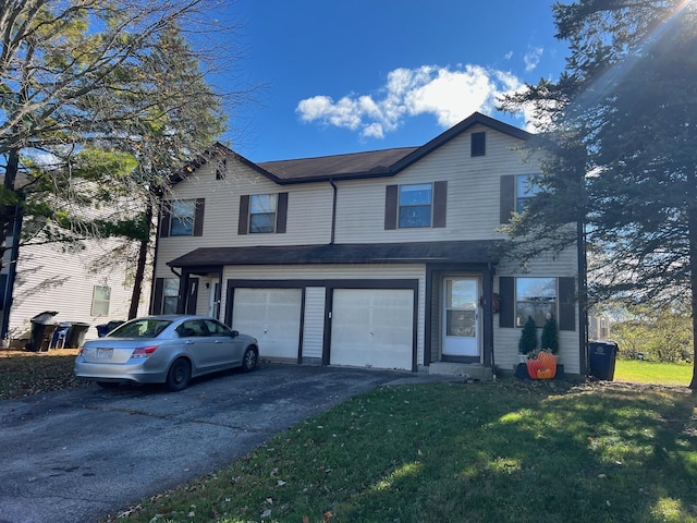 view of front property with a front lawn and a garage