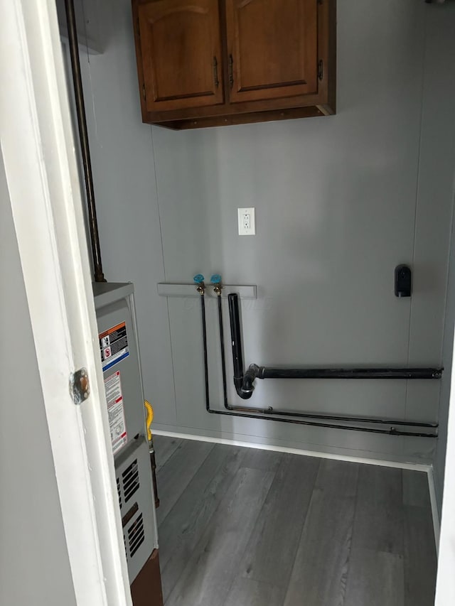 interior space with cabinets, dark wood-type flooring, and washer hookup