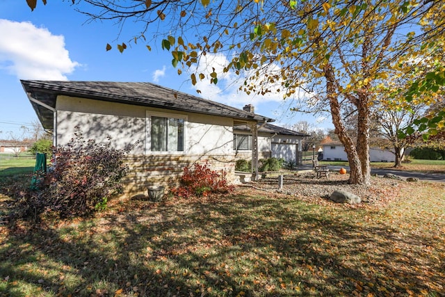 rear view of property featuring a lawn